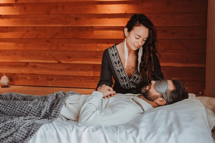Private Psilocybin Session Support A facilitator offering relational support to a participant during a private psilocybin retreat session.